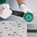 Tile installer cutting porcelain tile in tight corner with Termit 3 inch blade