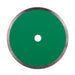 Green circular saw blade with a white center on a white background