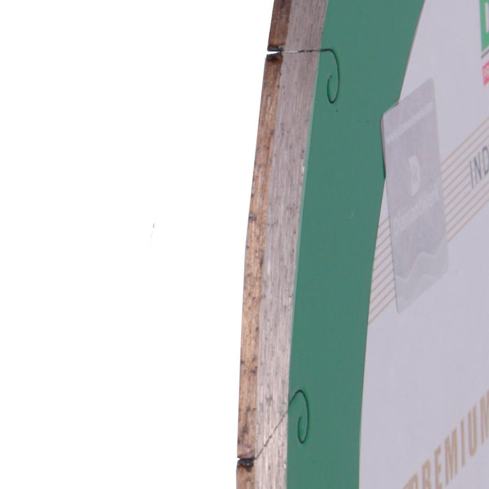 Close-up of a green and white sign with text and graphics on a wooden post.