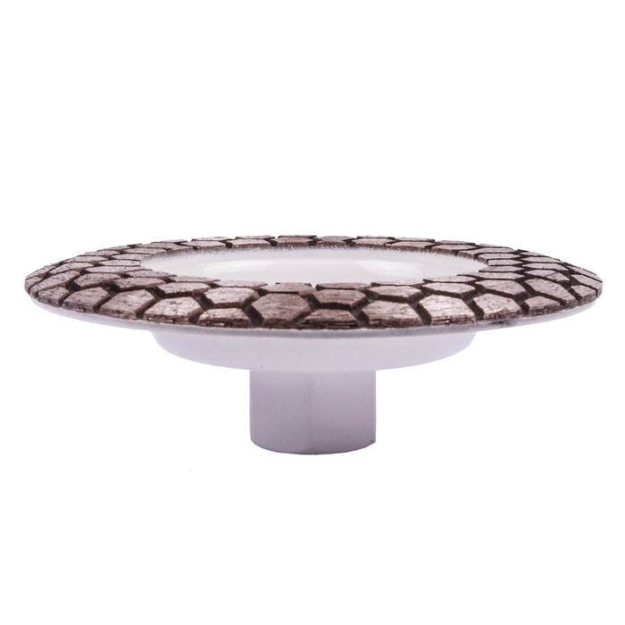 Decorative cake stand with patterned top and white base on a white background
