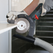 Tile professional using TileDUSTER for dust-free ceramic edge grinding