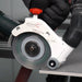 Mechanic roller tool with a red handle being used on a gray surface.