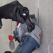 Hand using a circular saw with a 'Mechanic' brand attachment on a concrete surface.