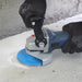 Contractor using ergonomic grinder handle for concrete grinding