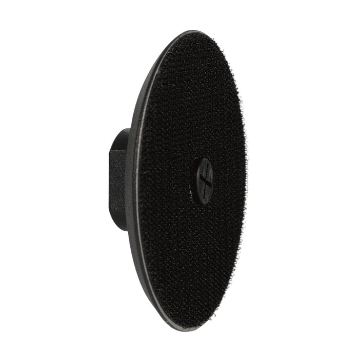 Black circular sponge pad on a white background
